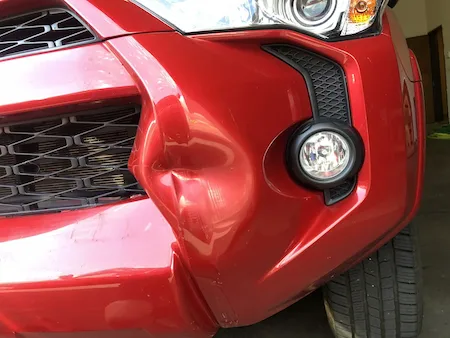 Dent before paintless dent repair on a Toyota Tacoma